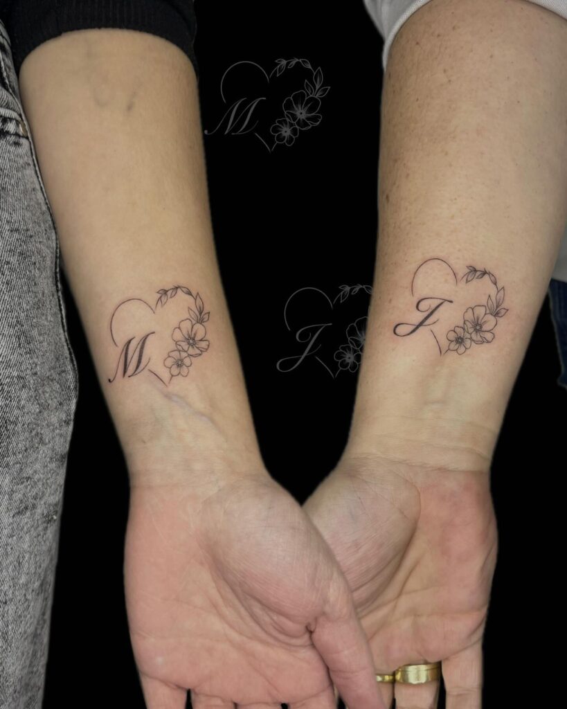 Heart and floral initial tattoo design for a meaningful mother-daughter connection