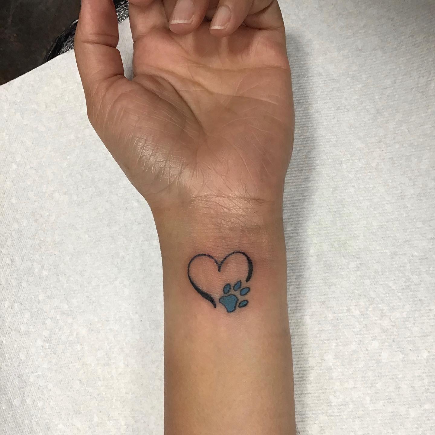 Heart and Paw Print Wrist Tattoo Perfect for Pet Lovers Symbolizing Deep Bond