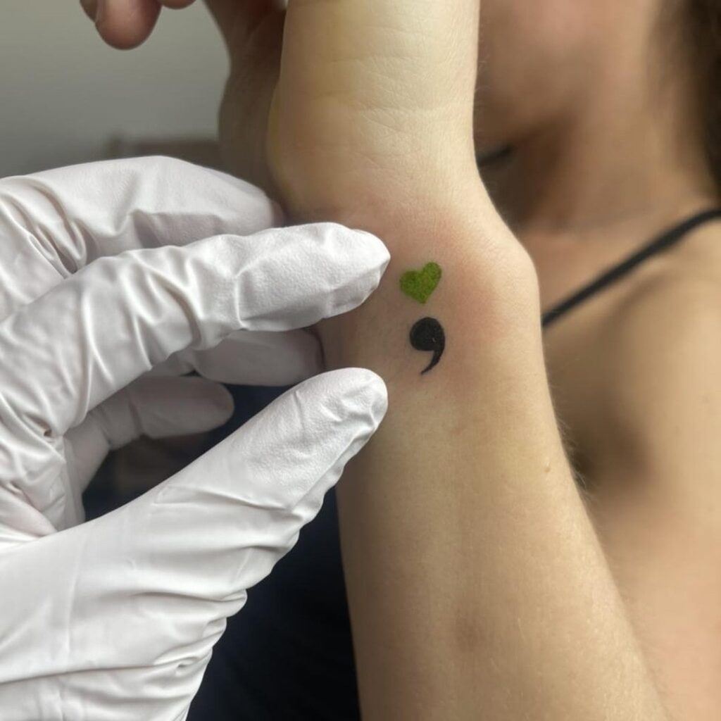 Heart Semicolon Tattoo on the Side of the Wrist: Green Heart Embrace