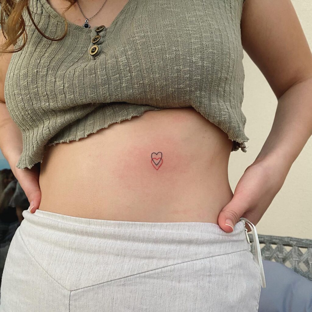 Heart tattoo on side of stomach bold and beautiful ink