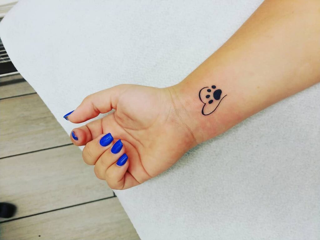 Heartfelt connection paw print inside an outline heart on the inner wrist
