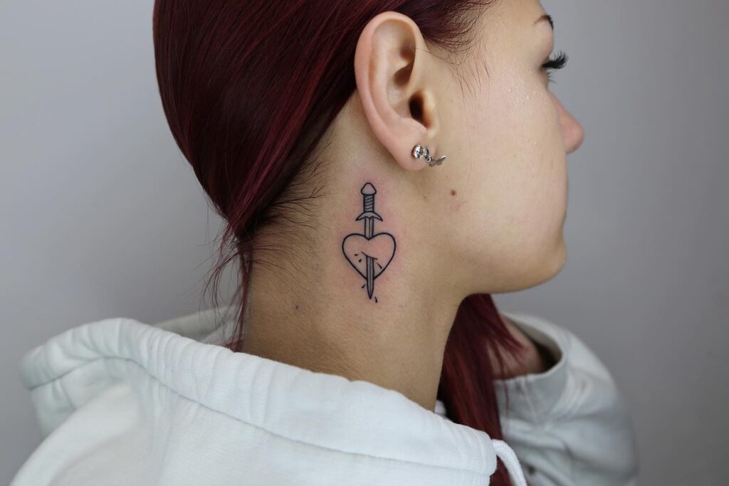 Heartfelt stab of art side neck tattoo featuring an outline heart for girls
