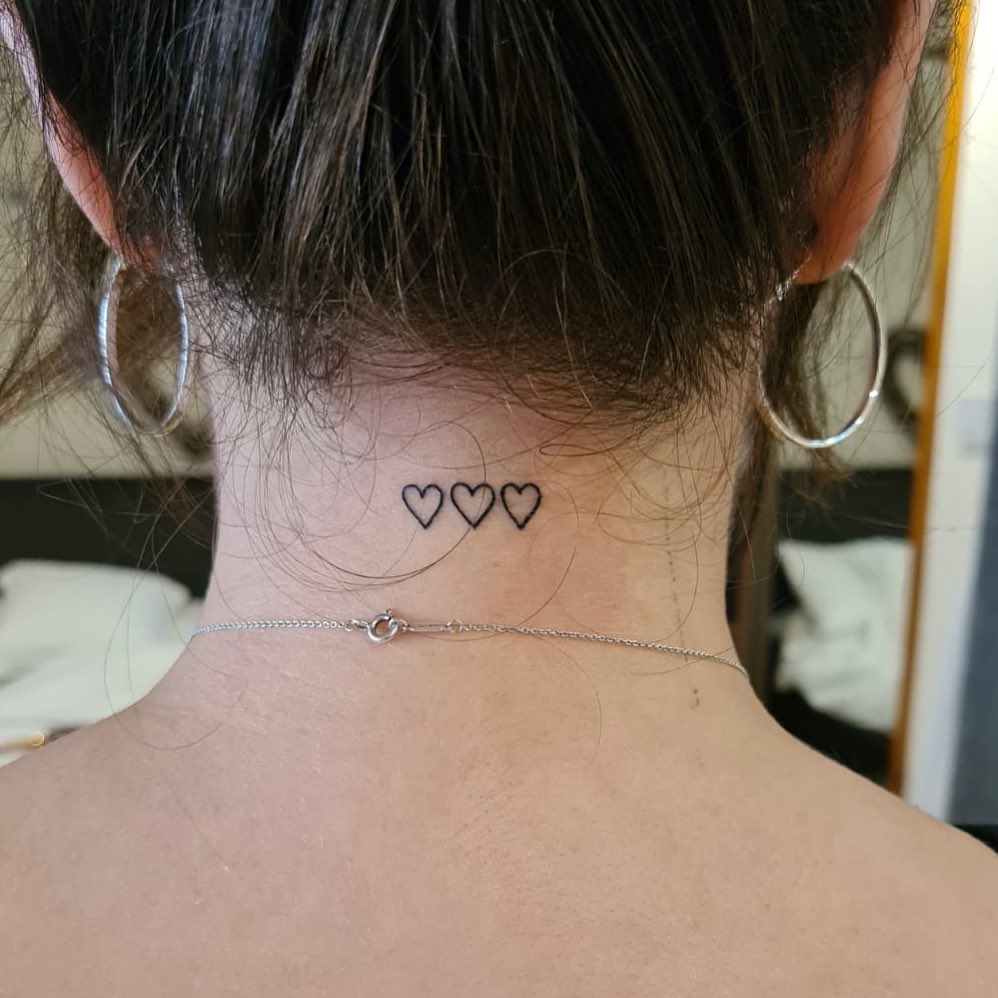 Hearts united small tattoo featuring three heart outlines on the nape