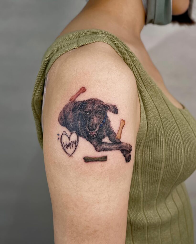 Heartwarming Retriever Tattoo with Bones on the Upper Arm: Labrador Love
