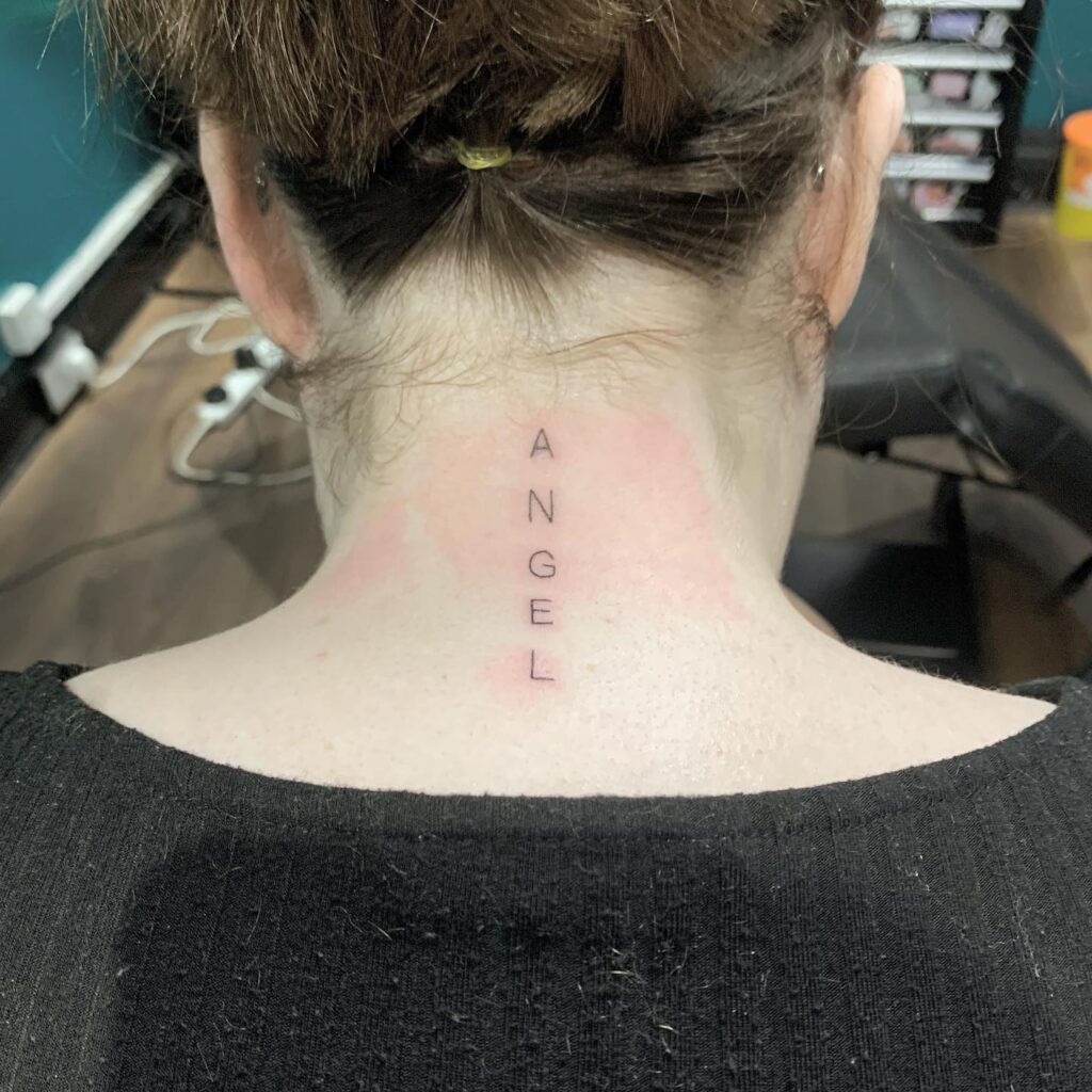 Heavenly expression vertical angel lettering tattoo on the back of the neck