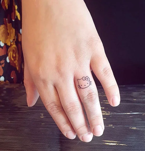 Hello kitty finger tattoo
