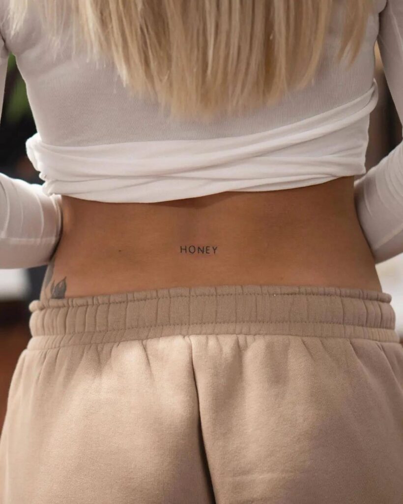 'Honey' Lettering Tattoo on the Lower Back for Females: Sweet Nectar