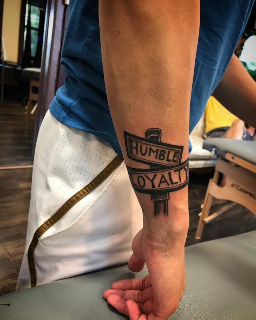 Humble Loyalty Street Sign Tattoo: A Mark of Authenticity and Dedication