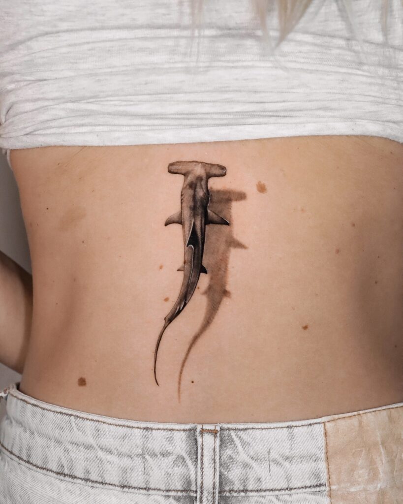 Hyperrealistic hammerhead shark tattoo on torso with 3D shading