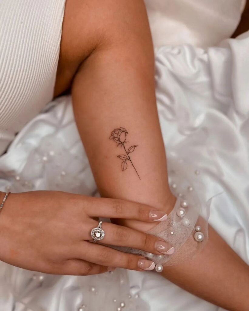 Iconic rose biceps tattoo: A tiny yet powerful floral statement