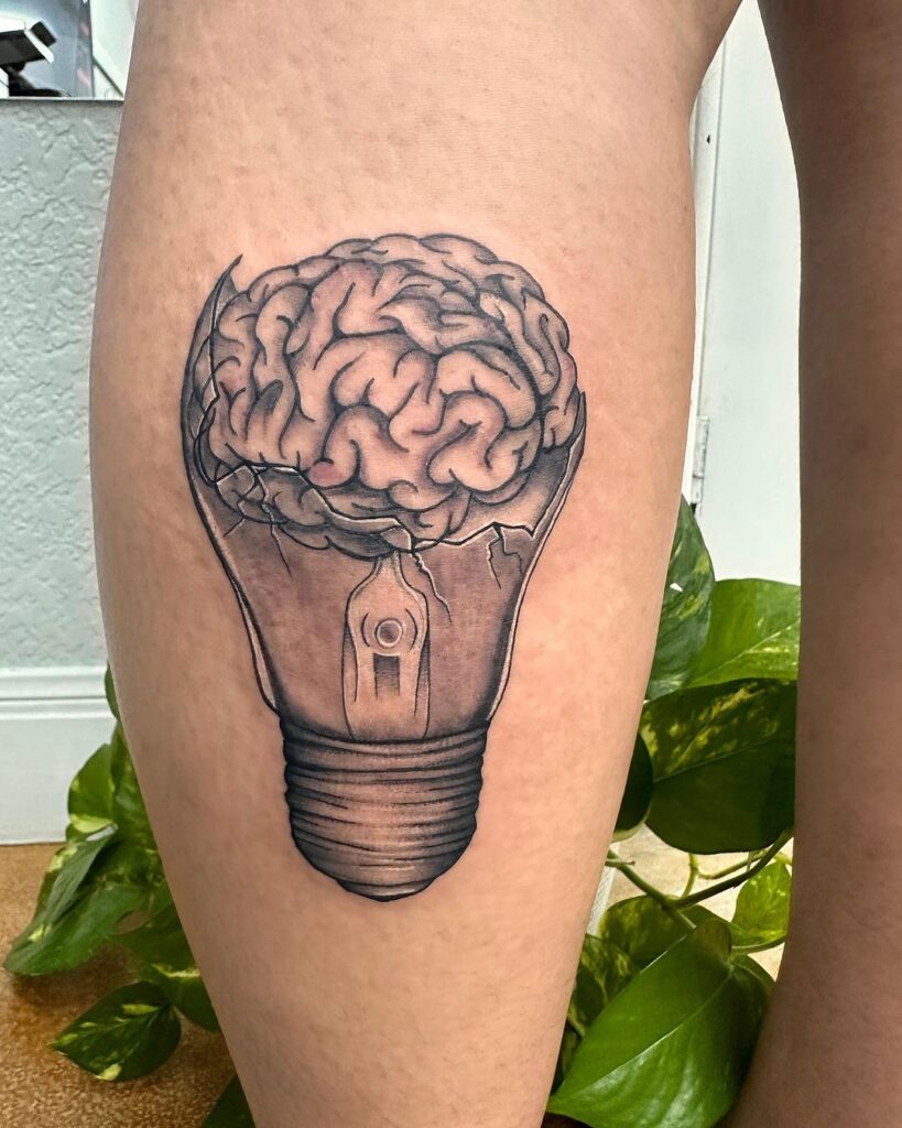 Idea and brain tattoo a 'light bulb moment' on the calf 