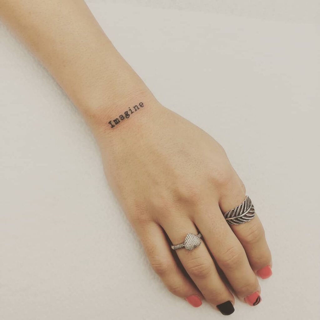 Imagine script wrist tattoo unveiling simplicity and elegance in wrist lettering