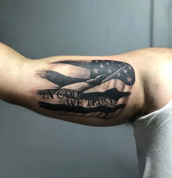 In god we trust bicep tattoo
