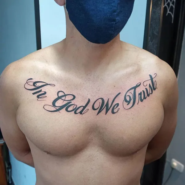 In god we trust chest tattoo