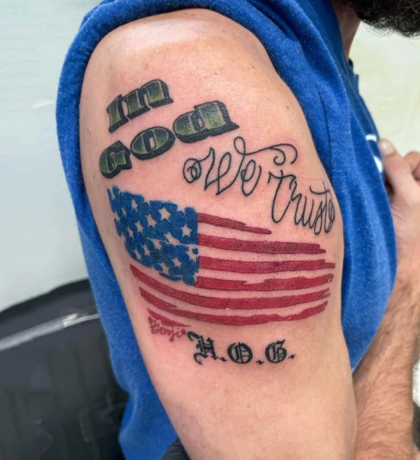 In god we trust tattoo on arm
