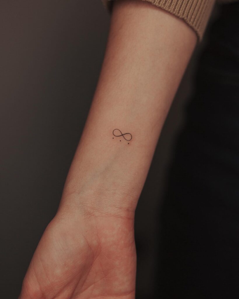 Infinity Symbol and Three Dots Tattoo on the Forearm: Eternal Connection