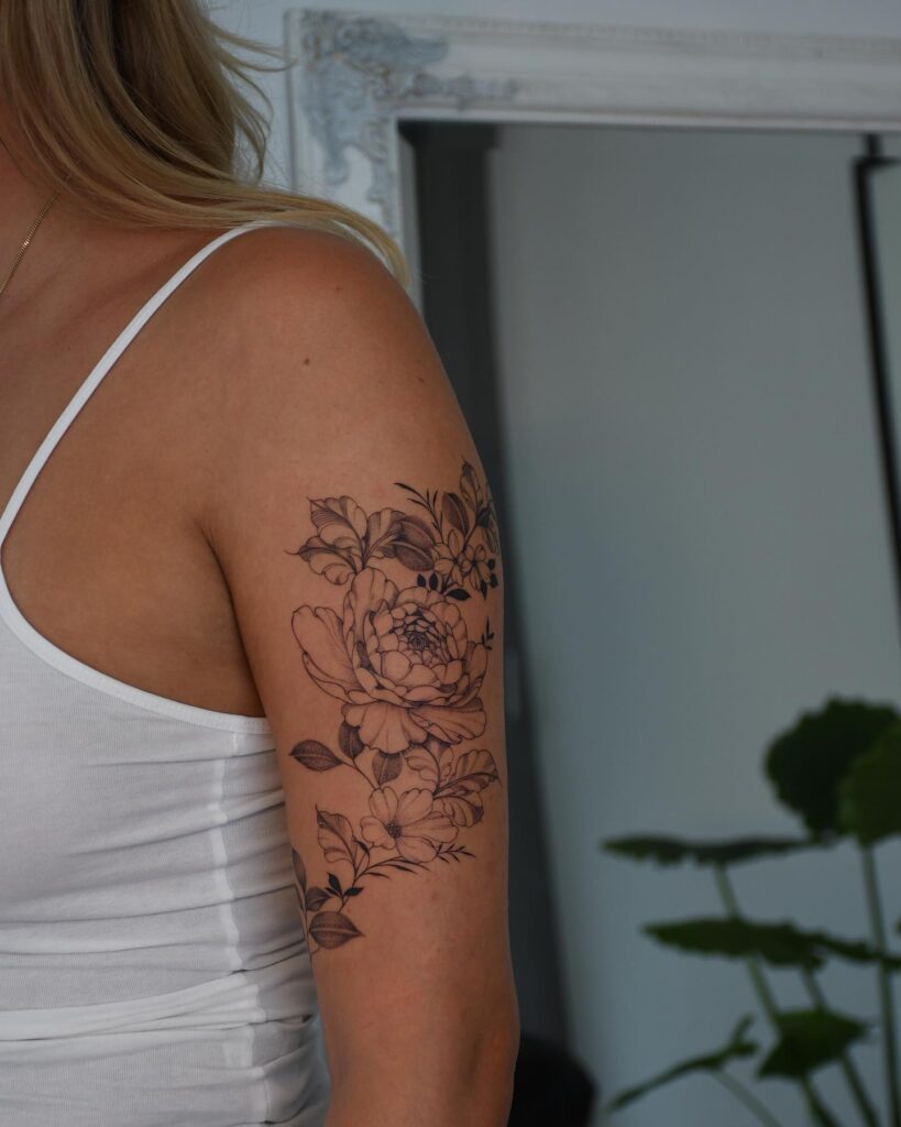 Inked Blossoms: A Fine Line Floral Tattoo for Empowered Women on Half Sleeve