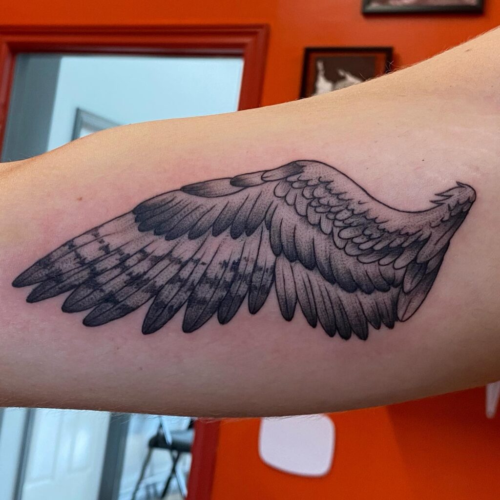 Inner Bicep Tattoo of Owl Wings in Black and Grey for a Touch of Mystery: Owl's Embrace