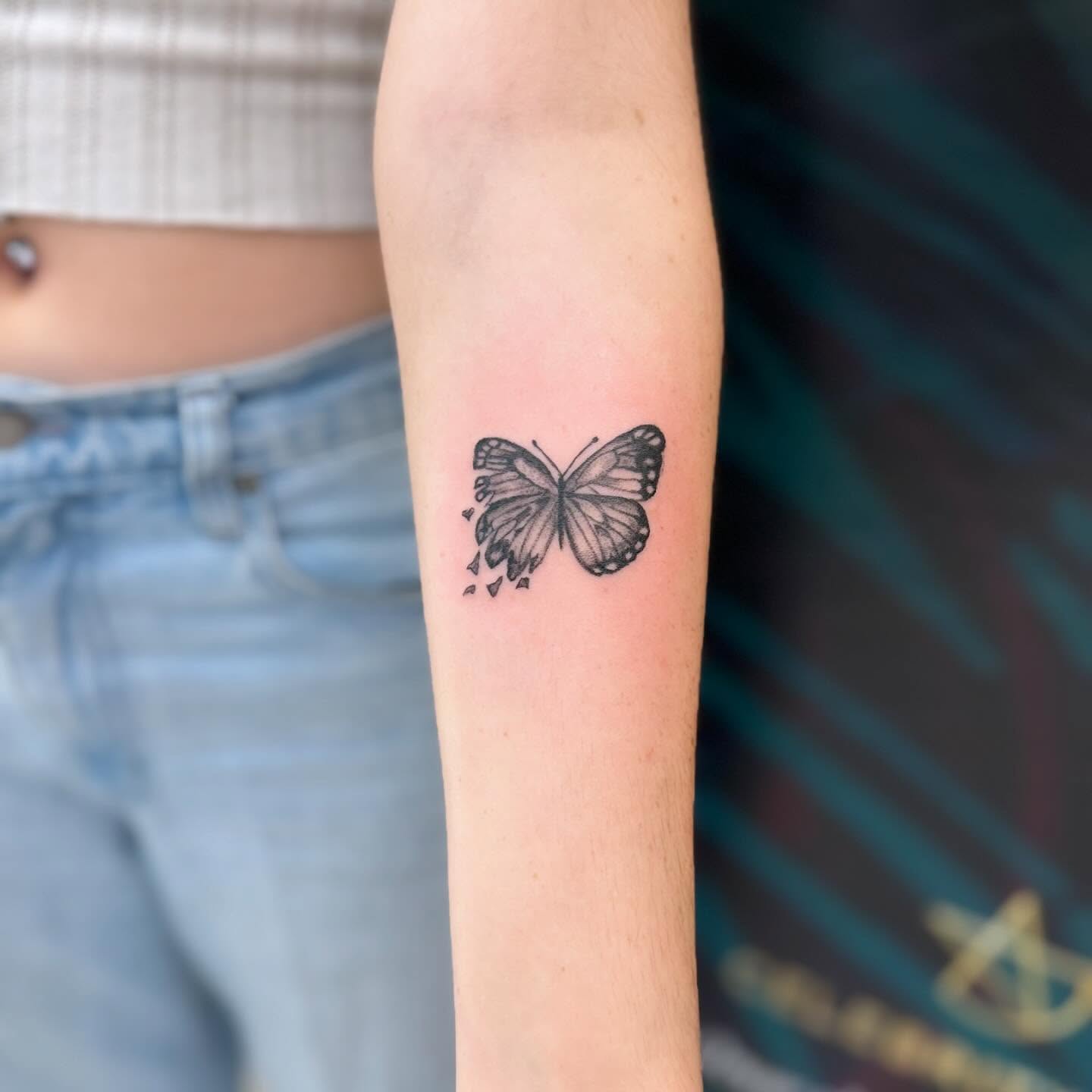 Inner forearm butterfly tattoo with dissolving wing meaning