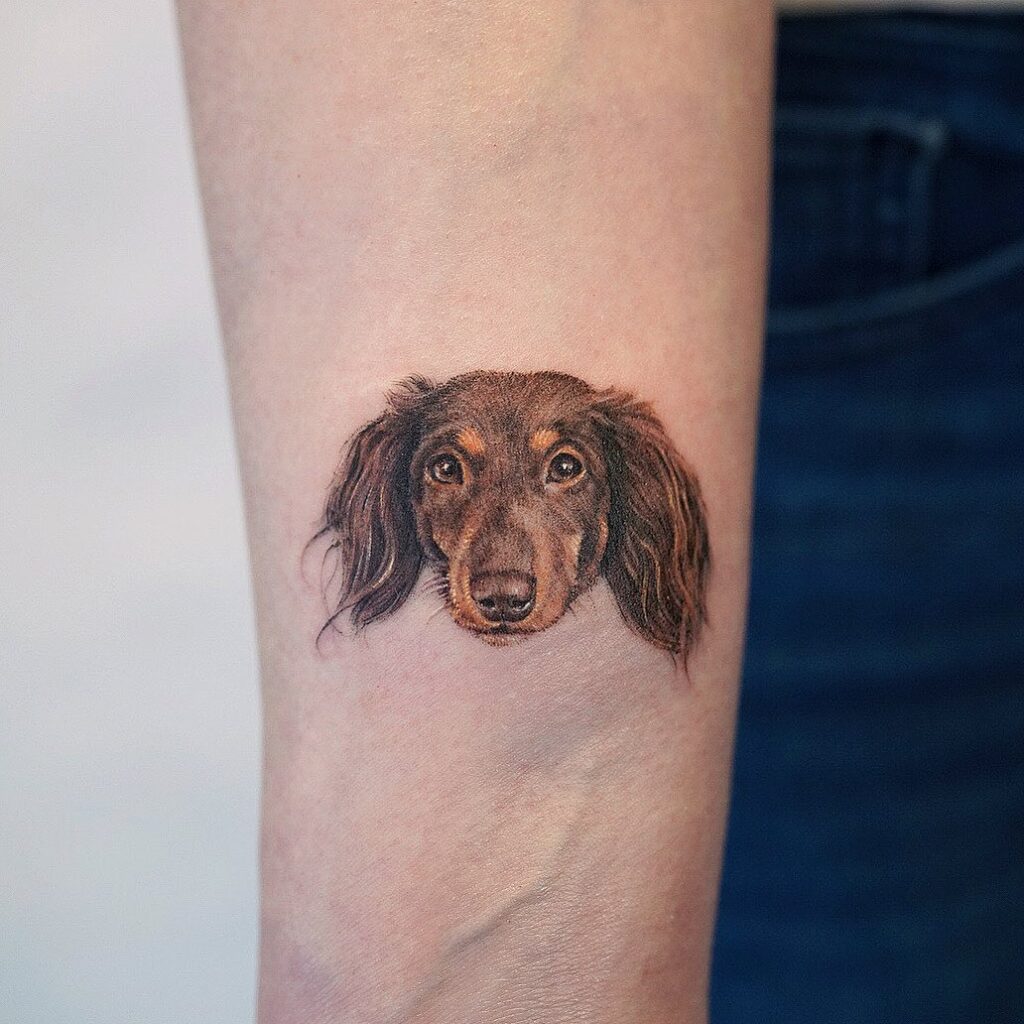 Inner forearm canine companion dog face tattoo