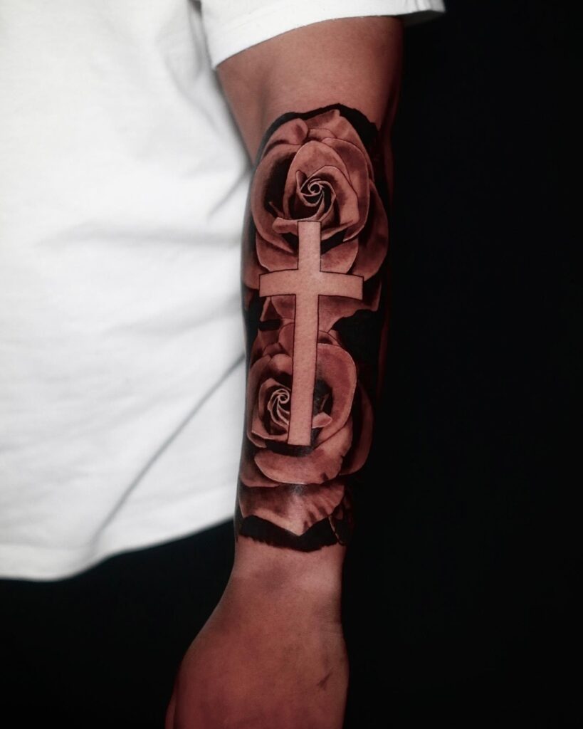 Inner forearm lower half sleeve cross with roses tattoo - a testament of faith and love