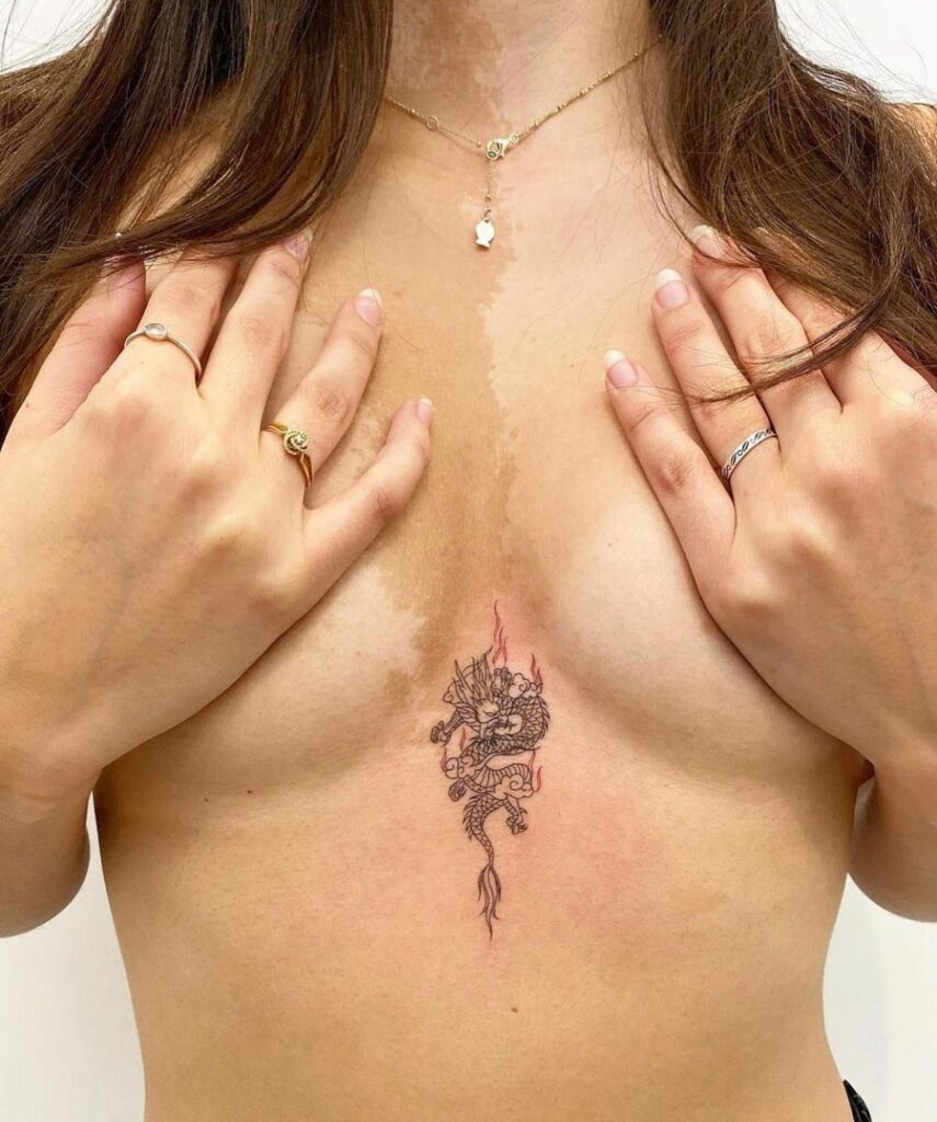 Intricate dragon sternum tattoo with fine linework and mystic symbolism