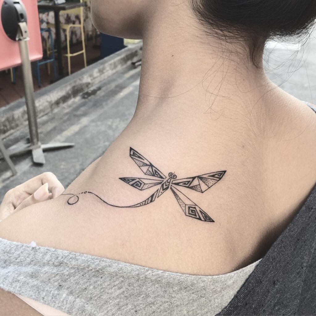 Intricate Geometric Dragonfly Tattoo on Upper Back with Ornamental Details