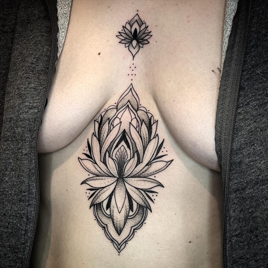 Intricate lotus flower sternum tattoo spiritual symbolism