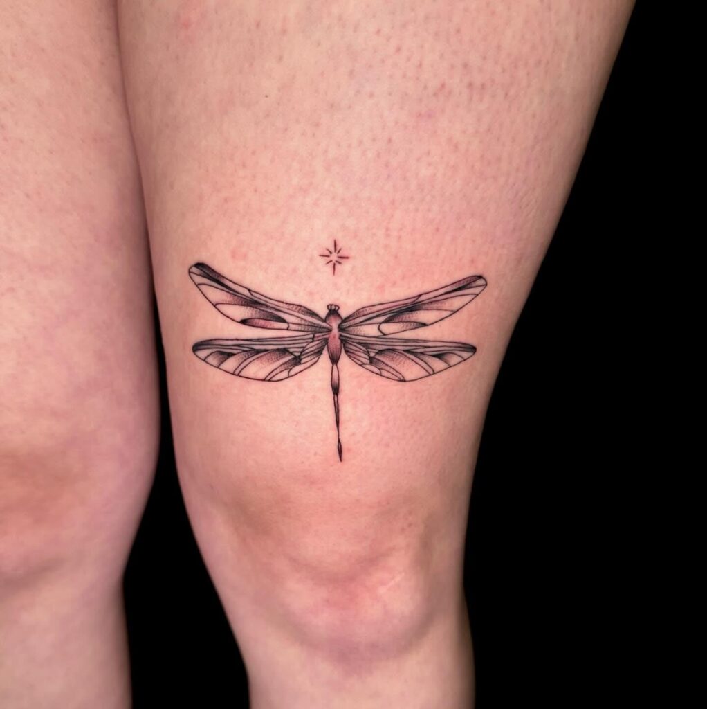 Intricately Detailed Thigh Dragonfly Tattoo with a Touch of Mysticism