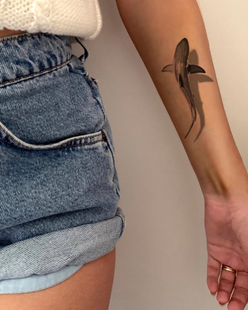 Intricately shaded forearm shark tattoo creating a lifelike effect with a powerful presence