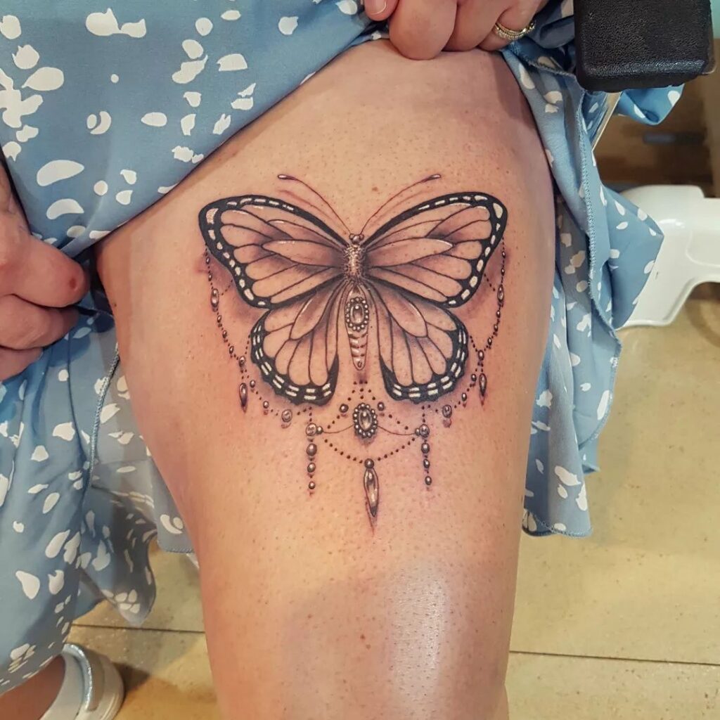 Jewels of the air black and grey butterfly on thigh