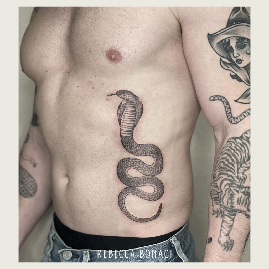 King cobra tattoo on the rib mens black and gray serpent