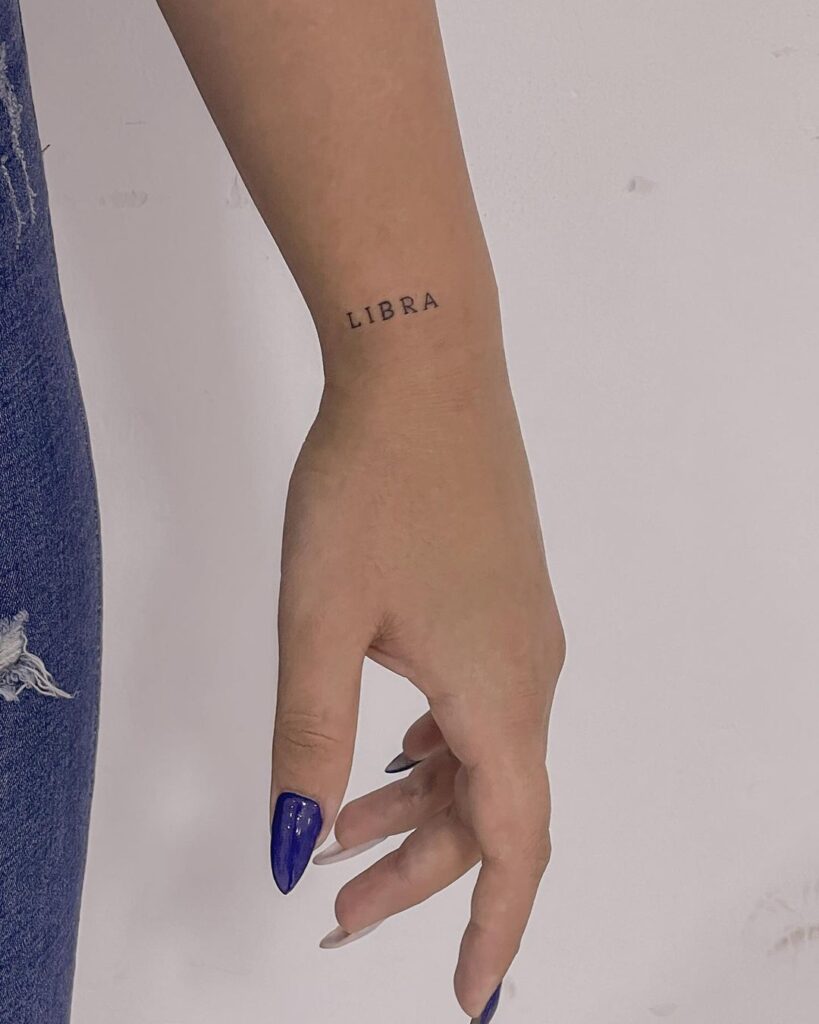 LIBRA word lettering side wrist tattoo personal expression