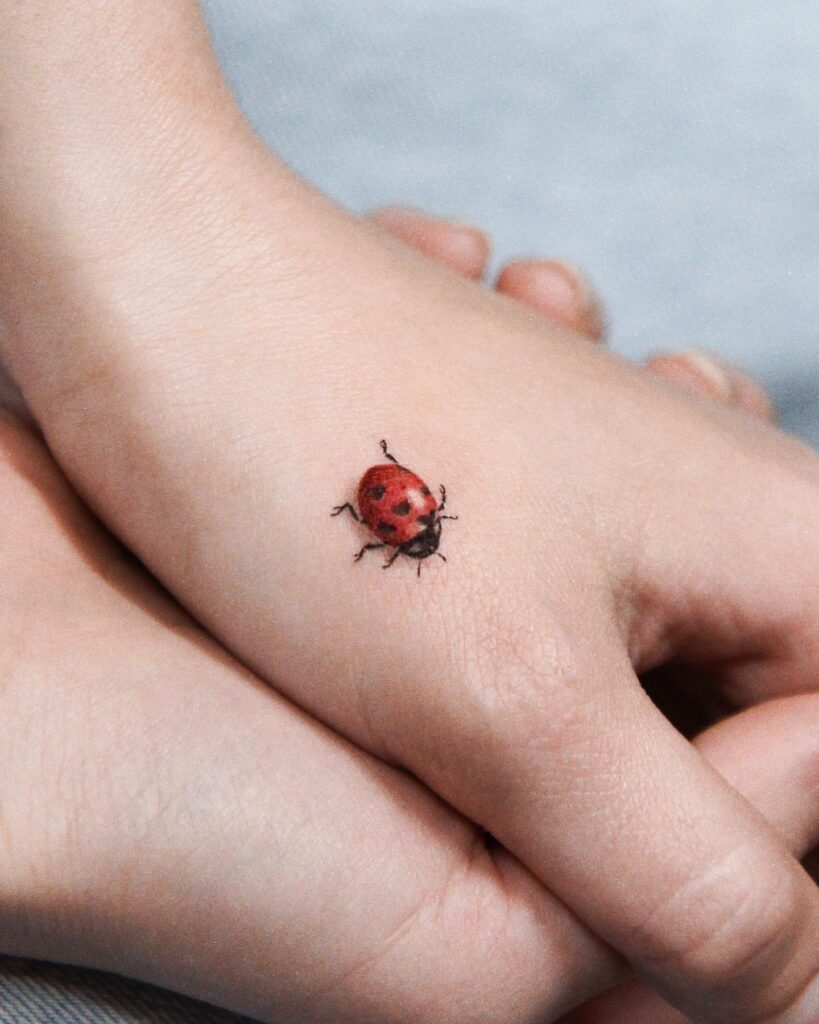 Ladybug Tattoo on Back of the Hand for Girl: Delicate and Charming Ink
