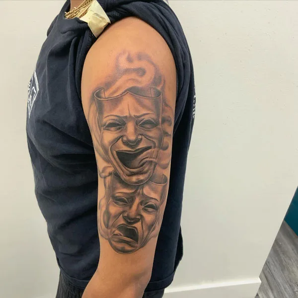 Laugh now cry later arm tattoo