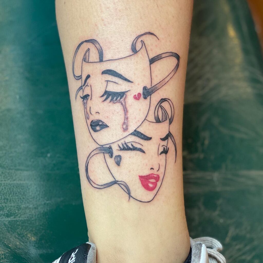 Laugh Now Cry Later Tattoo: Girl's Face Masks Above the Ankle