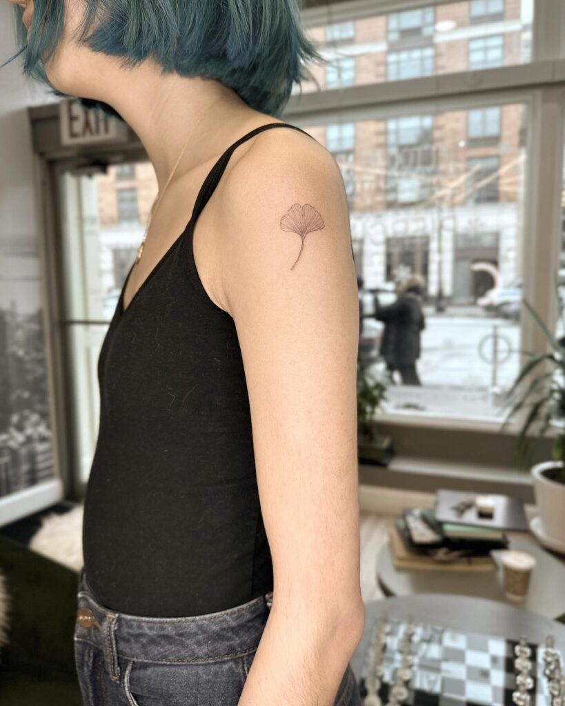 Leaf Tattoo on the Upper Arm for Elegant Women: Ginkgo Grace