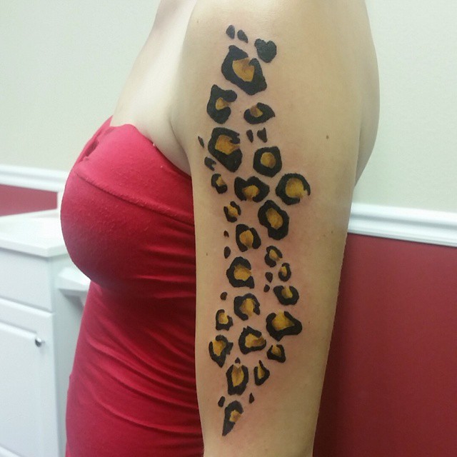 Leopard print arm tattoo for females embrace your inner feline