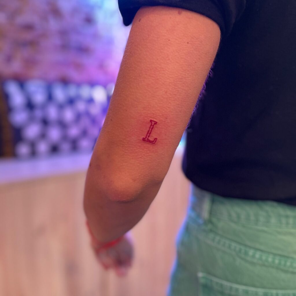 Letter 'L' Tattoo: Behind the Elbow Charm, a Hidden Gem in an Unusual Spot