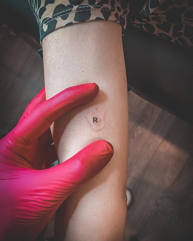 Letter 'R' Tattooed on the Inner Arm for Women: Inner Arm Elegance