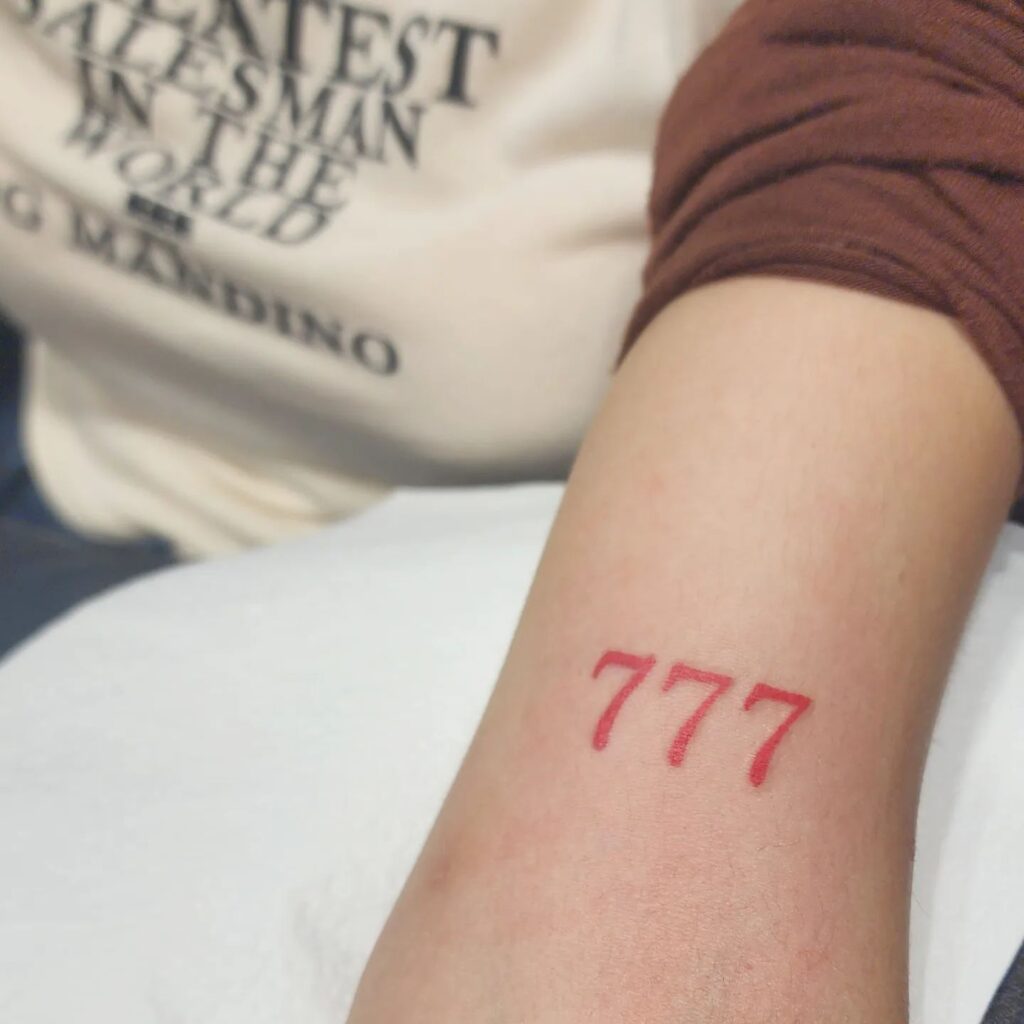 Light red 777 above the elbow a feminine touch to a lucky number rosy resilience 
