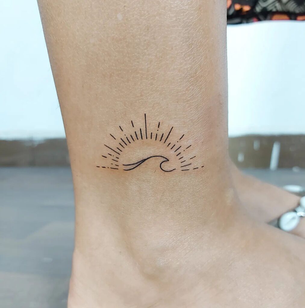 Linework sun and ocean tattoos on ankle girl minimalist and evocative ink art
