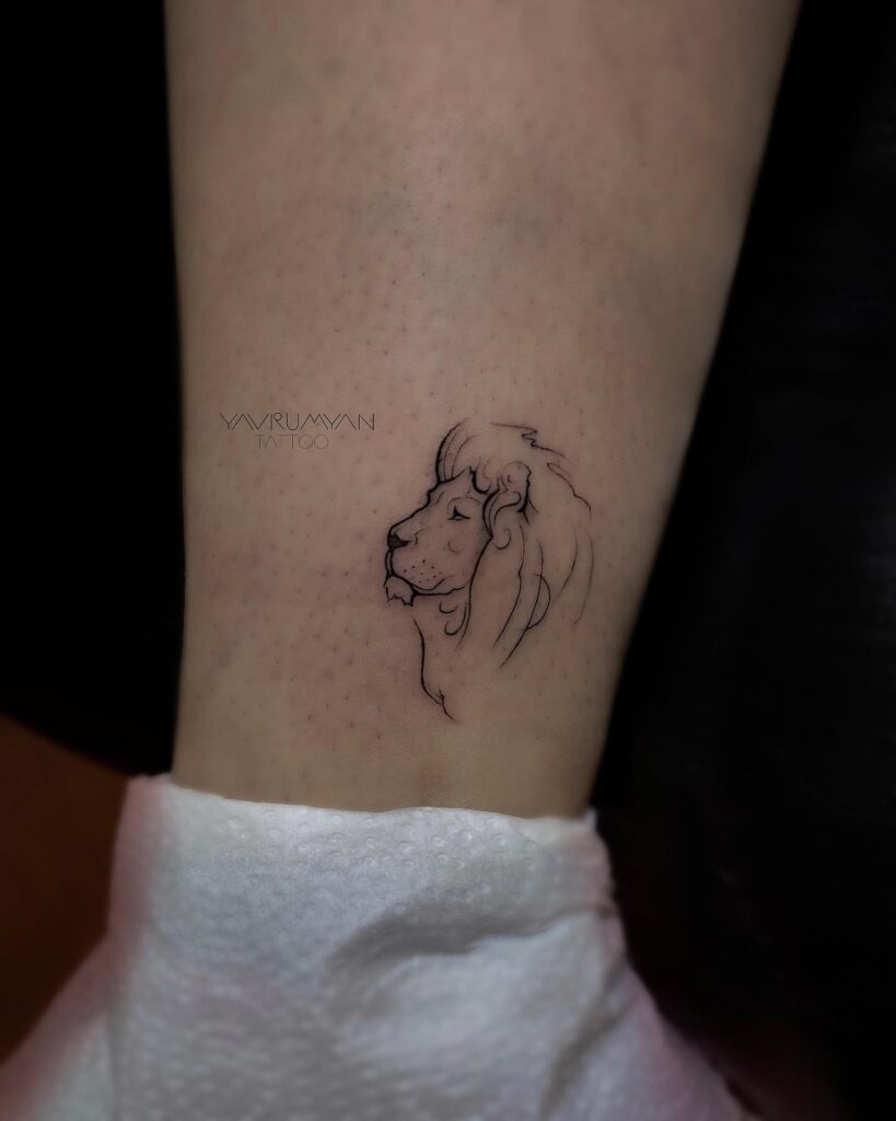 Lion face outline fineline tattoo above the ankle: fineline side view