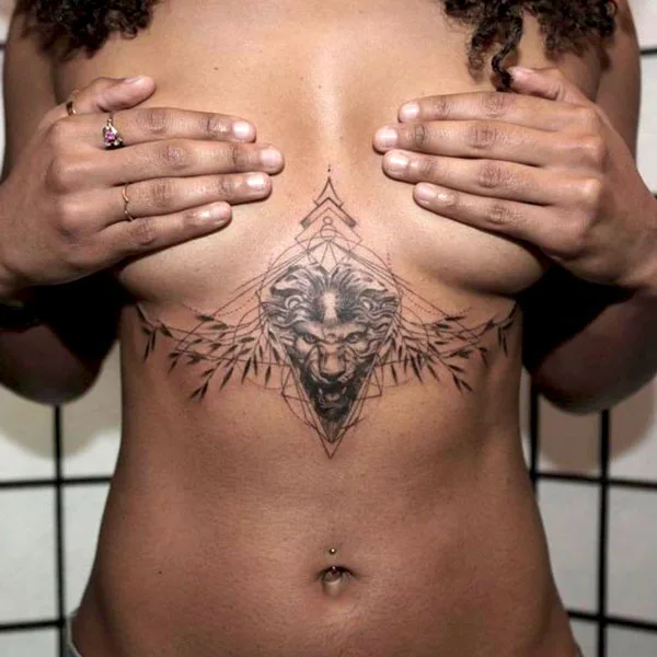 Lion under breast tattoo