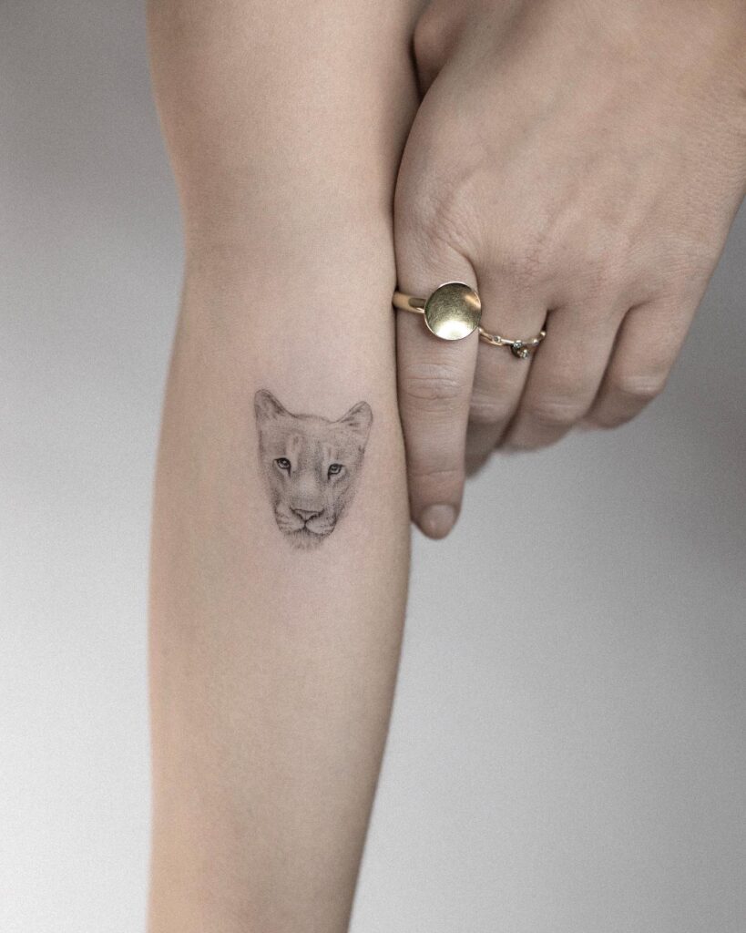 Lioness Head Tattoo in Black and Grey Commanding the Forearm: Fierce Majesty