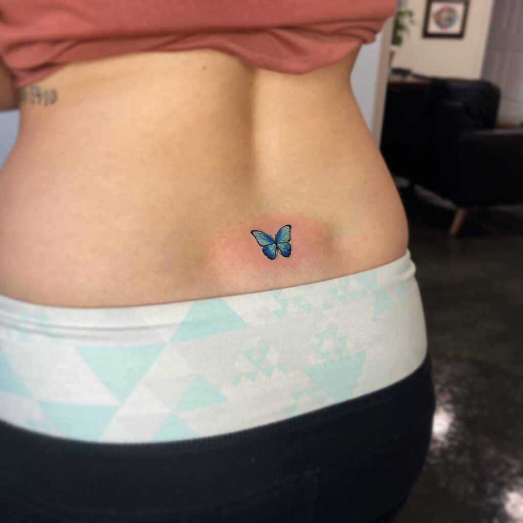 Little Blue Color Butterfly Tattoo, a Delight on the Lower Back: Butterfly Whimsy
