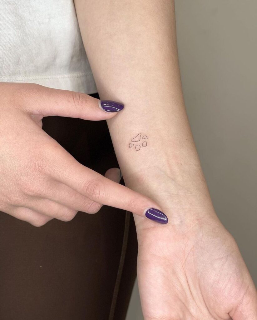 Little Dog Paw Tattoo Adorning the Inner Forearm, a Sweet Tribute: Paw Print Symphony
