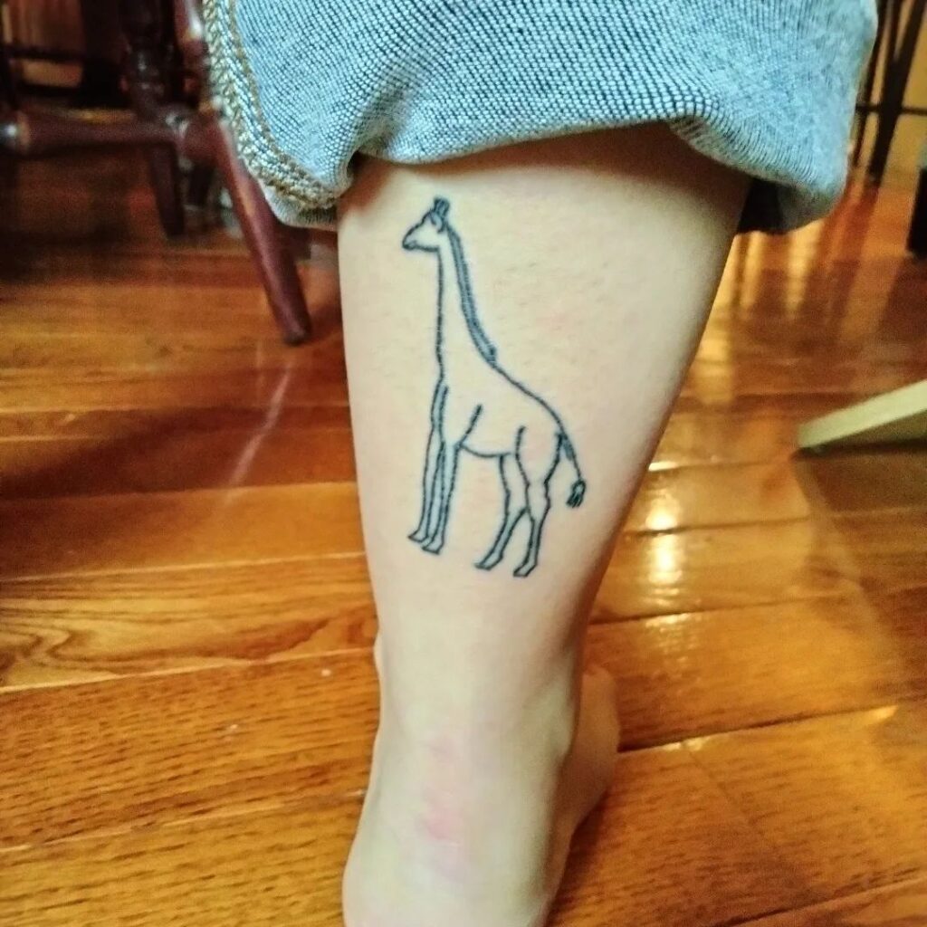 Little Outline Tattoo of a Giraffe on the Back of the Ankle: Giraffe Grace 