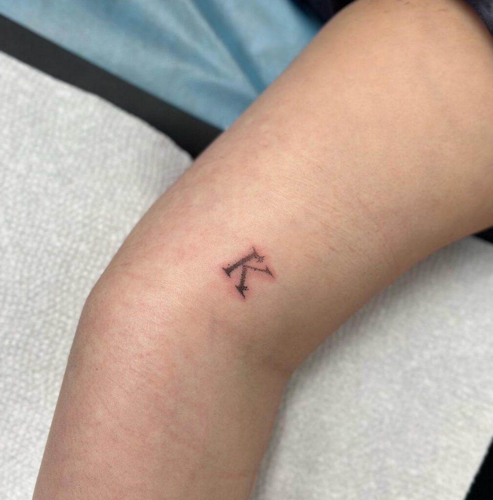 Little Sparkly 'K' Tattoo Above the Elbow: Sparkling Charm