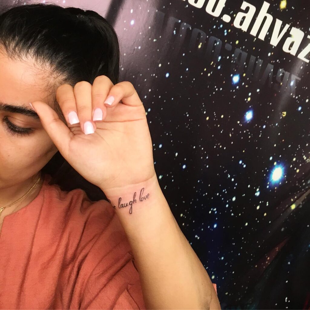 Live Laugh Love Font Tattoo on the Inner Wrist: Wrist Elegance
